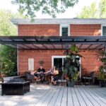 backyard patio cover with family playing cards
